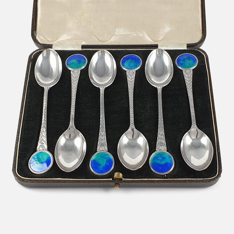 the sterling silver and enamel teaspoons viewed in their case