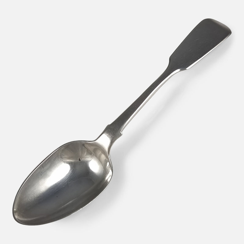 one of the teaspoons viewed diagonally with handle to background