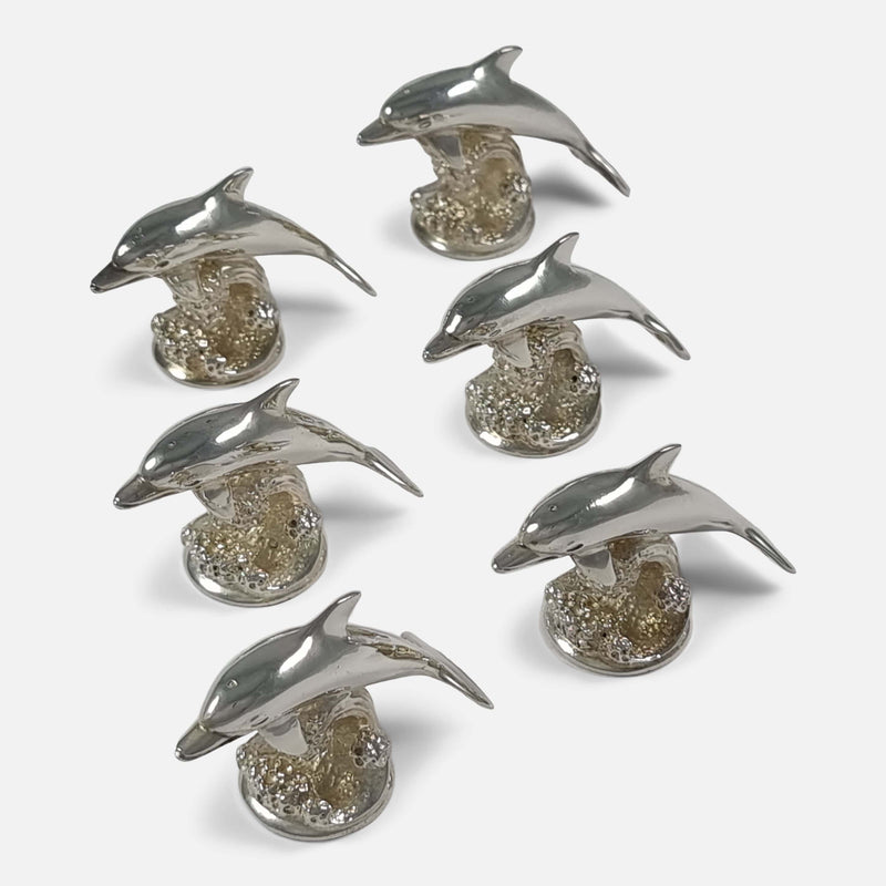 a birds eye view of the set of 6 dolphin menu holders facing slightly towards bottom left hand corner of image