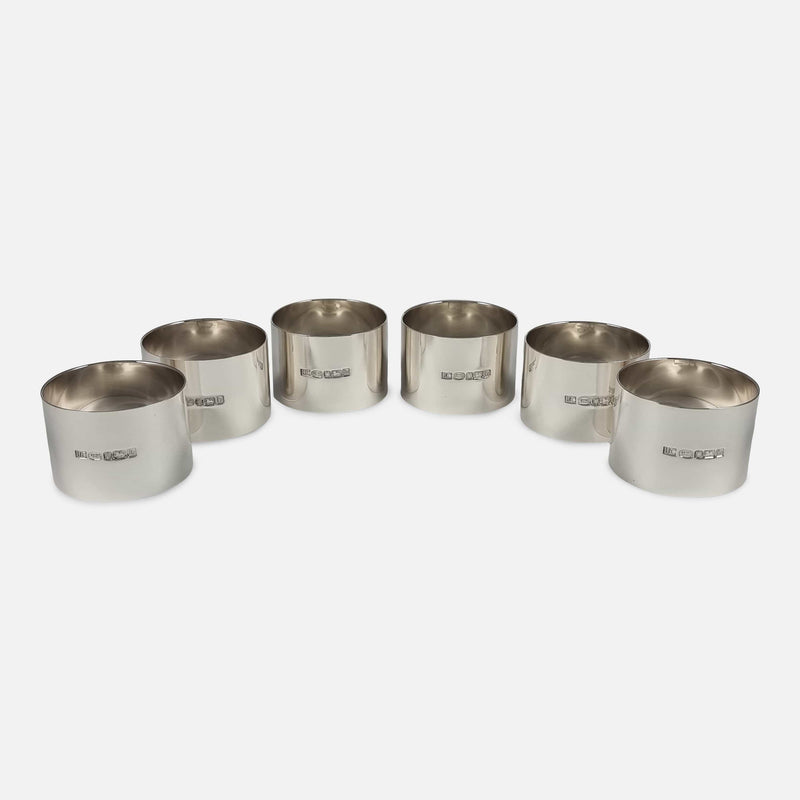 the napkin rings viewed in a horseshoe formation with hallmarks to the front