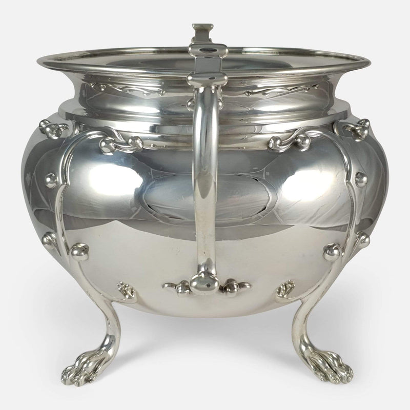 the silver bowl turned to the side with handle to forefront