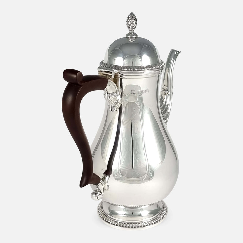 the coffee pot angled with handle to the forefront and pointing slightly towards the left