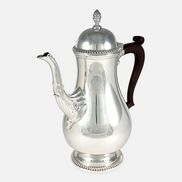 the coffee pot angled with spout to the forefront and pointing slightly towards the left