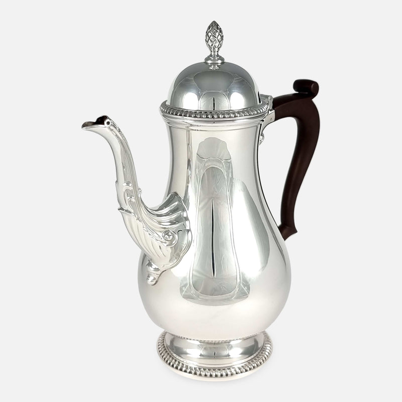 the coffee pot angled with spout to the forefront and pointing slightly towards the left