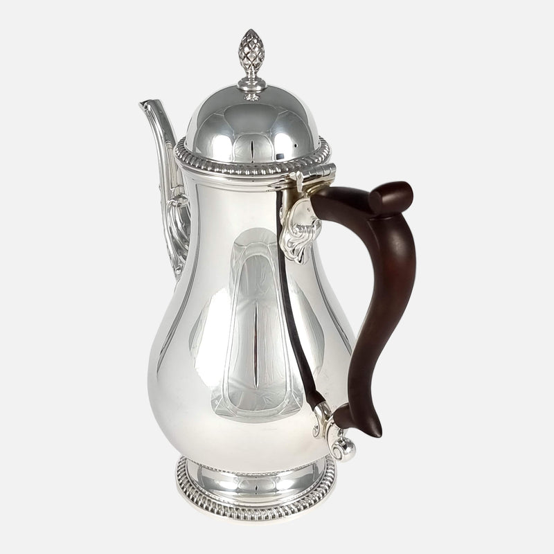 the coffee pot angled with handle to the forefront and pointing slightly towards the right