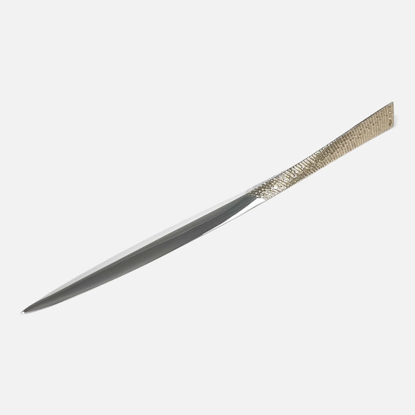 the Stuart Devlin sterling silver letter opener viewed at a slight angle with tip pointing towards the left side
