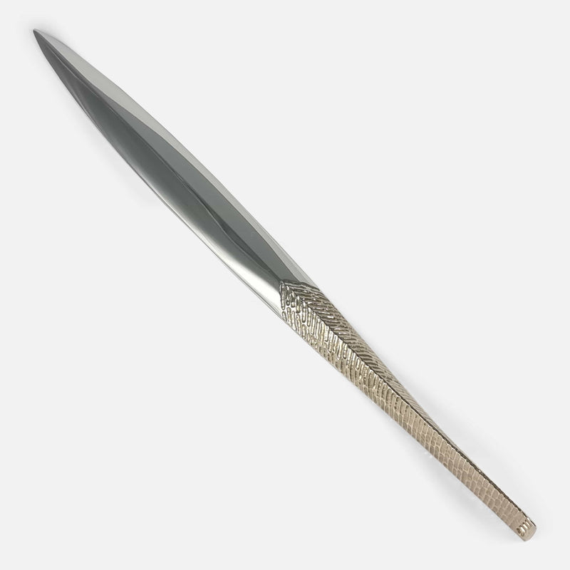the letter opener viewed diagonally with handle to forefront and pointing towards the right side