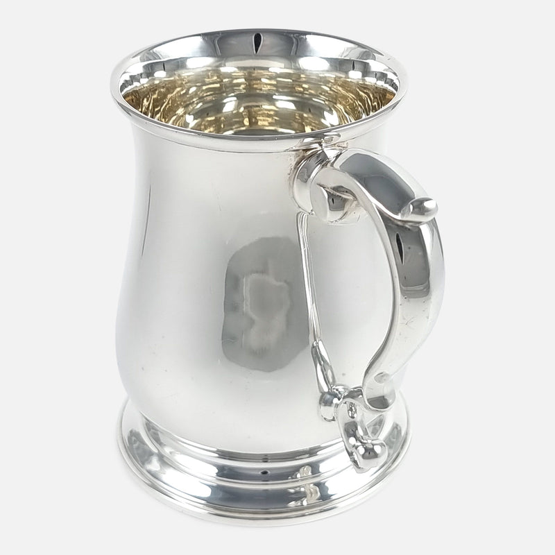 the mug with handle to forefront pointing slightly towards the right