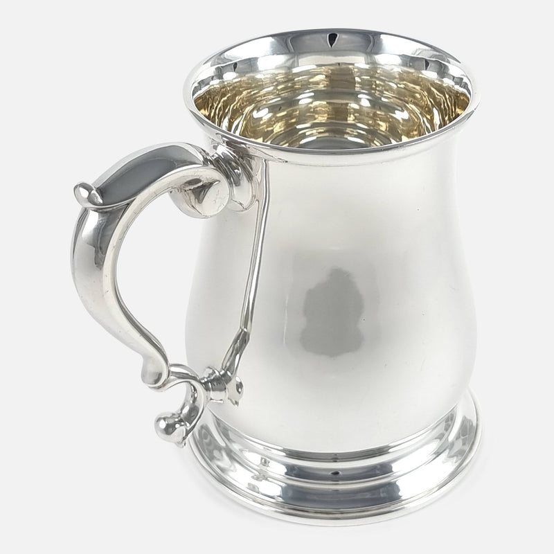 the mug with handle to forefront pointing slightly towards the left