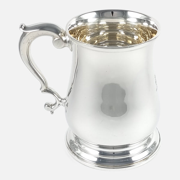 the sterling silver mug viewed side on with the handle pointing left