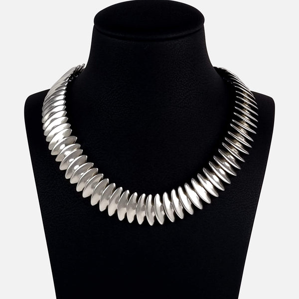 The Georg Jensen silver necklace viewed on a display bust