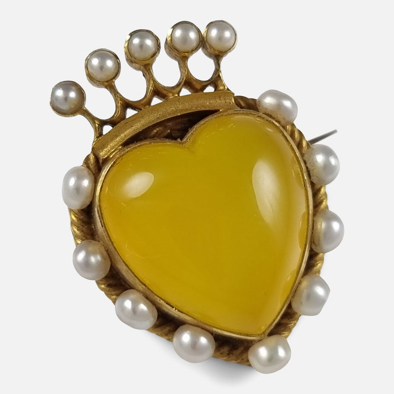 the gold brooch viewed at a slight angle