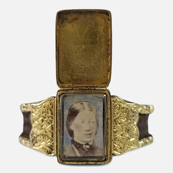 the Victorian 15 carat yellow gold sentimental portrait hair ring viewed from the front with hinged cover opened to reveal the portrait