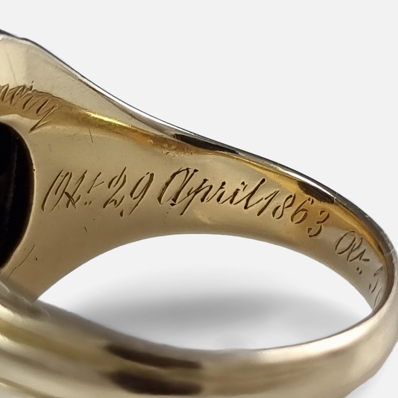 focused on a section of the inscription to the inside of the gold ring