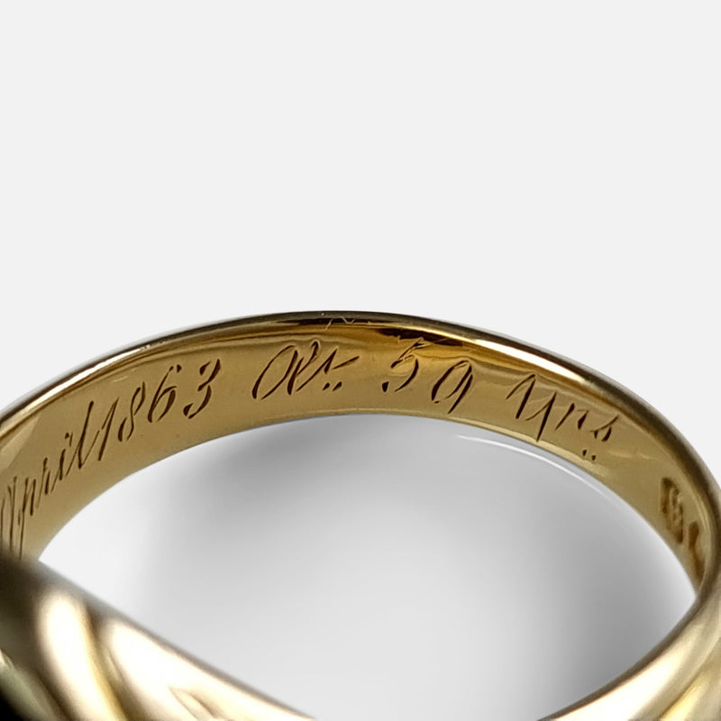 focused on a section of the inscription to the inside of the gold ring