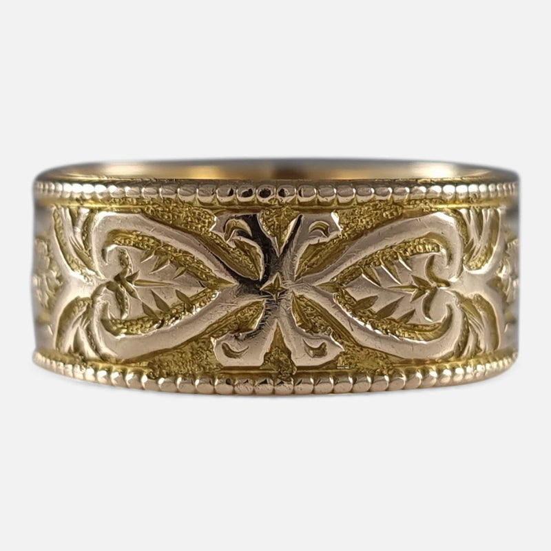 the Victorian 18ct yellow gold foliate engraved Keeper ring viewed from the front
