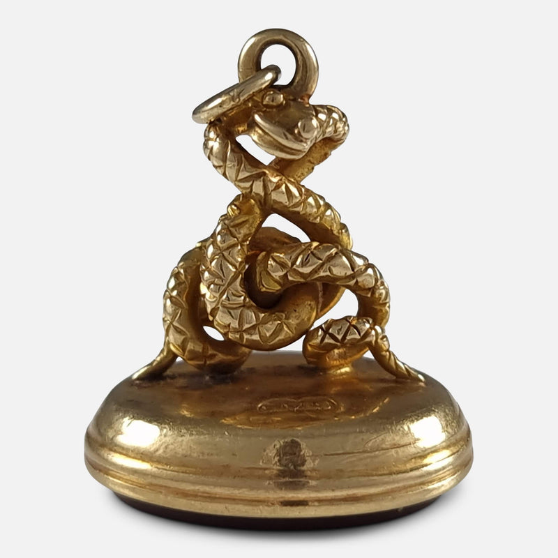 the gold fob pendant viewed with snake to the forefront