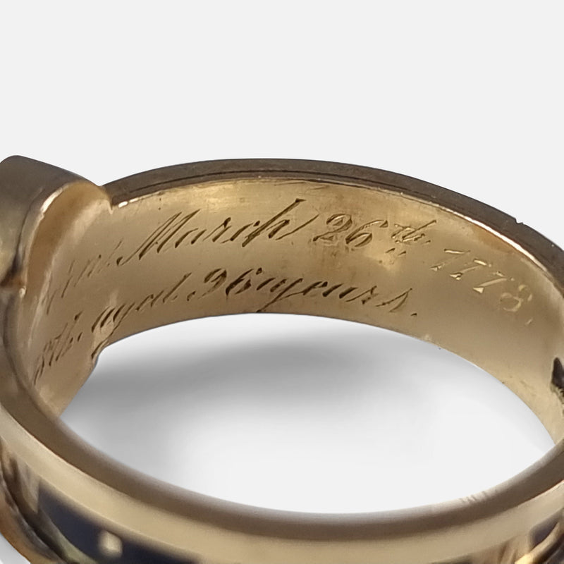 focused on a section of the inscription to the inside of the gold ring