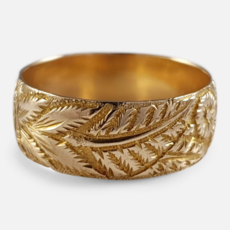 the foliate engraved wedding band in focus