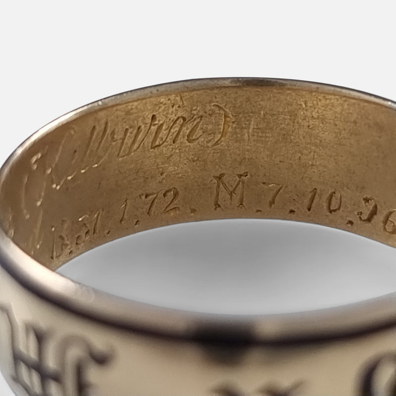 part of the engraved inscription to the interior of the ring in focus