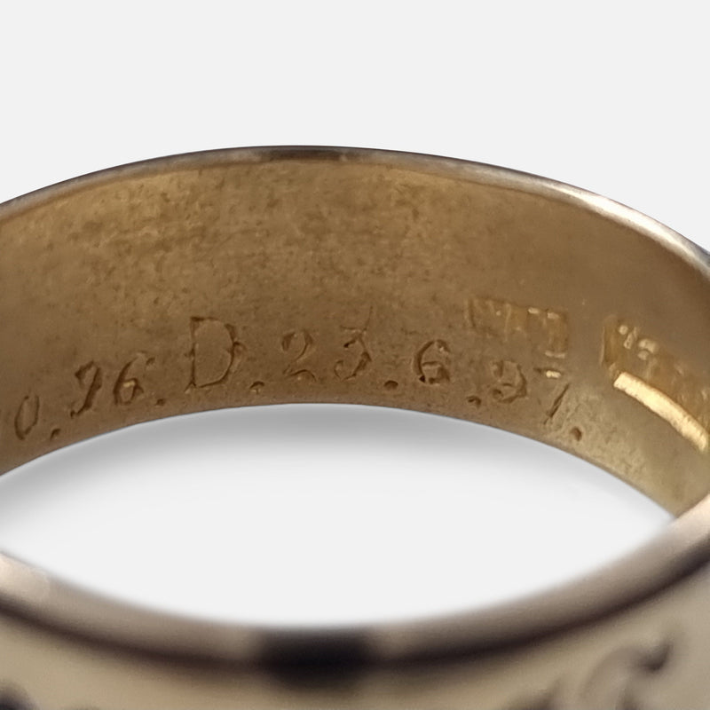 part of the engraved inscription to the interior of the ring in focus