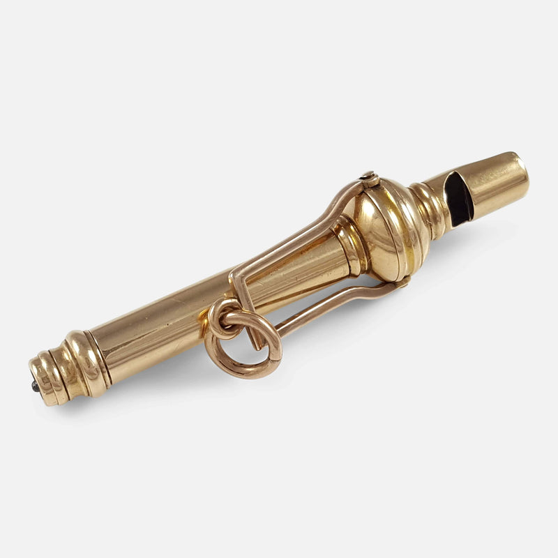 The gold propelling pencil and whistle viewed diagonally